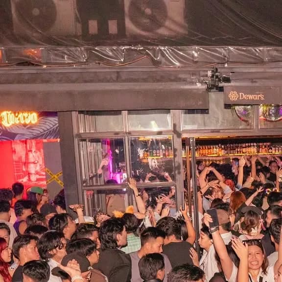 Packed dance floor in front of Sanctuary's illuminated bar