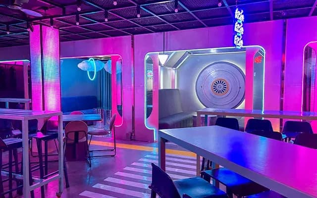 Neon-lit cabana seating inside The Fun Roof