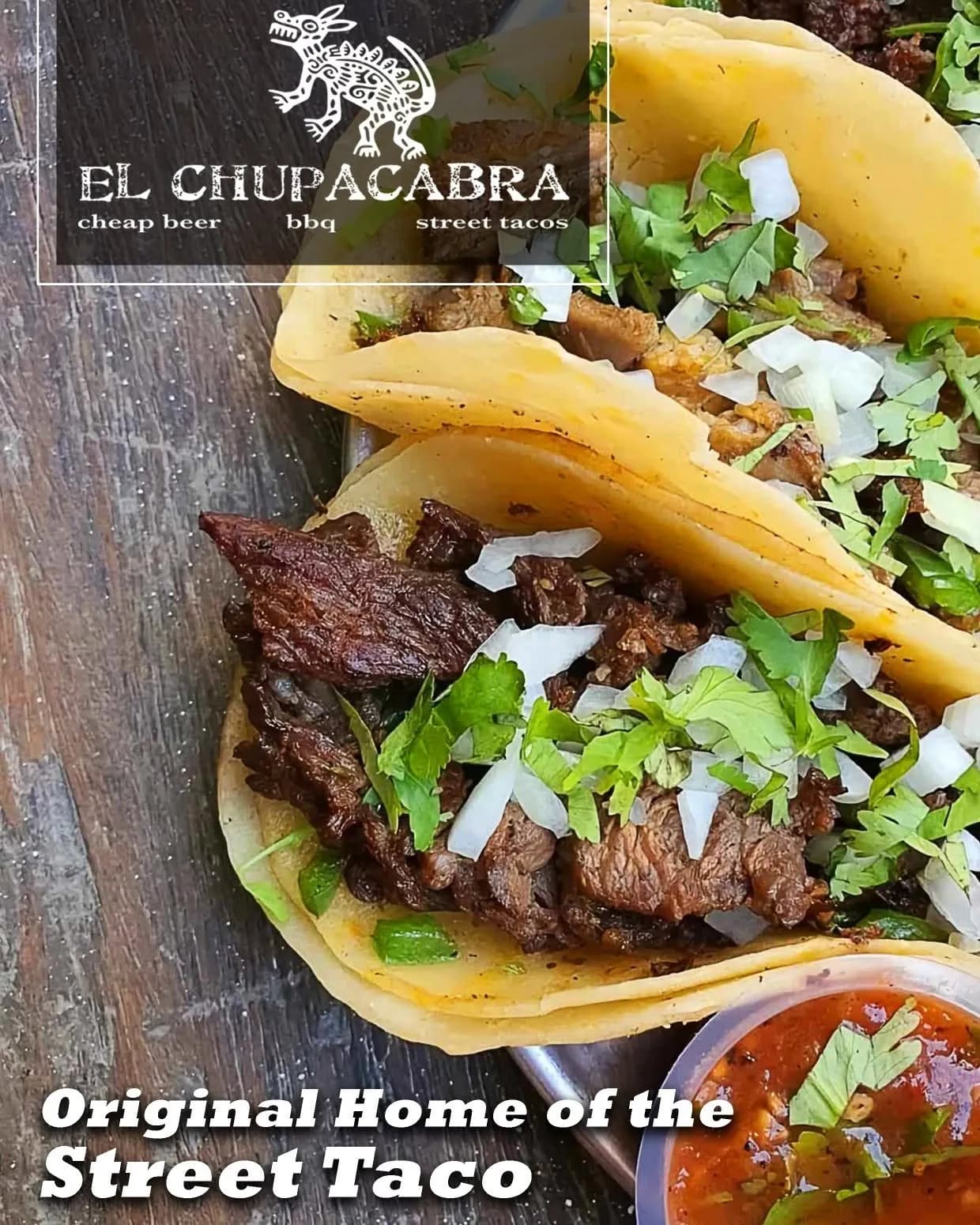 Three street tacos filled with grilled meat, onion and cilantro
