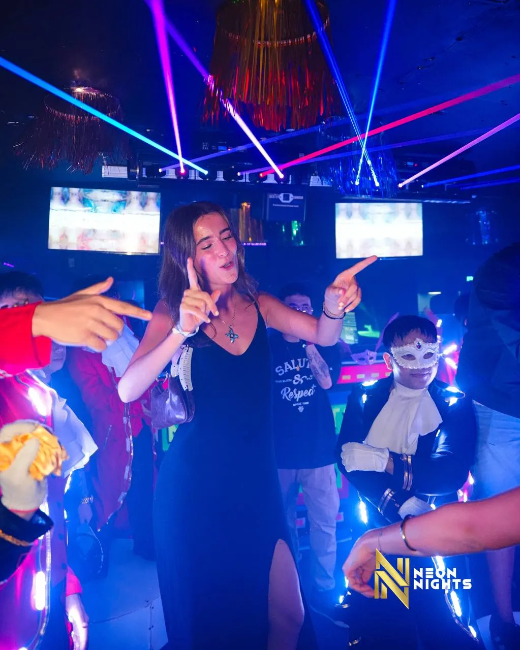 Guests dancing beneath blue and purple lights.