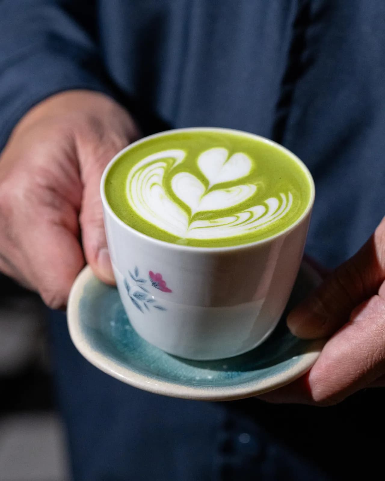 Hot matcha latte with heart-shaped foam art