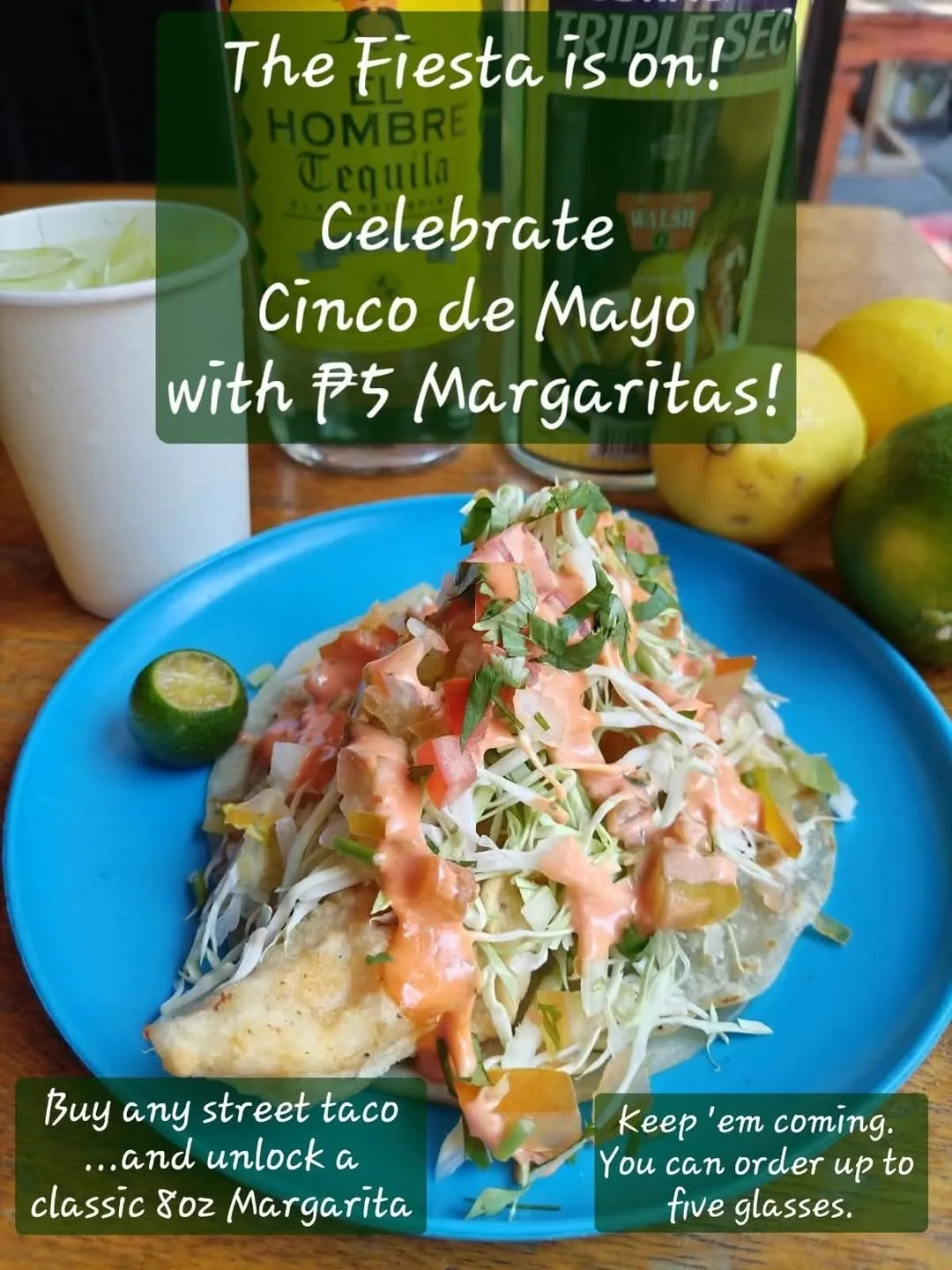 Fish taco with cabbage, tomatoes, herbs and pink sauce on a blue plate
