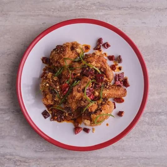 Mala crispy fried chicken wings with chillies and scallions