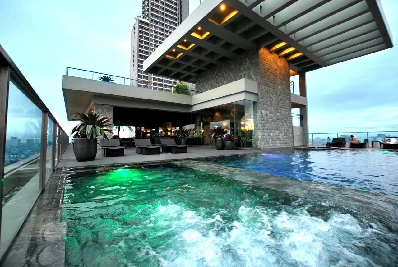 Rooftop pool deck and covered lounge at twilight